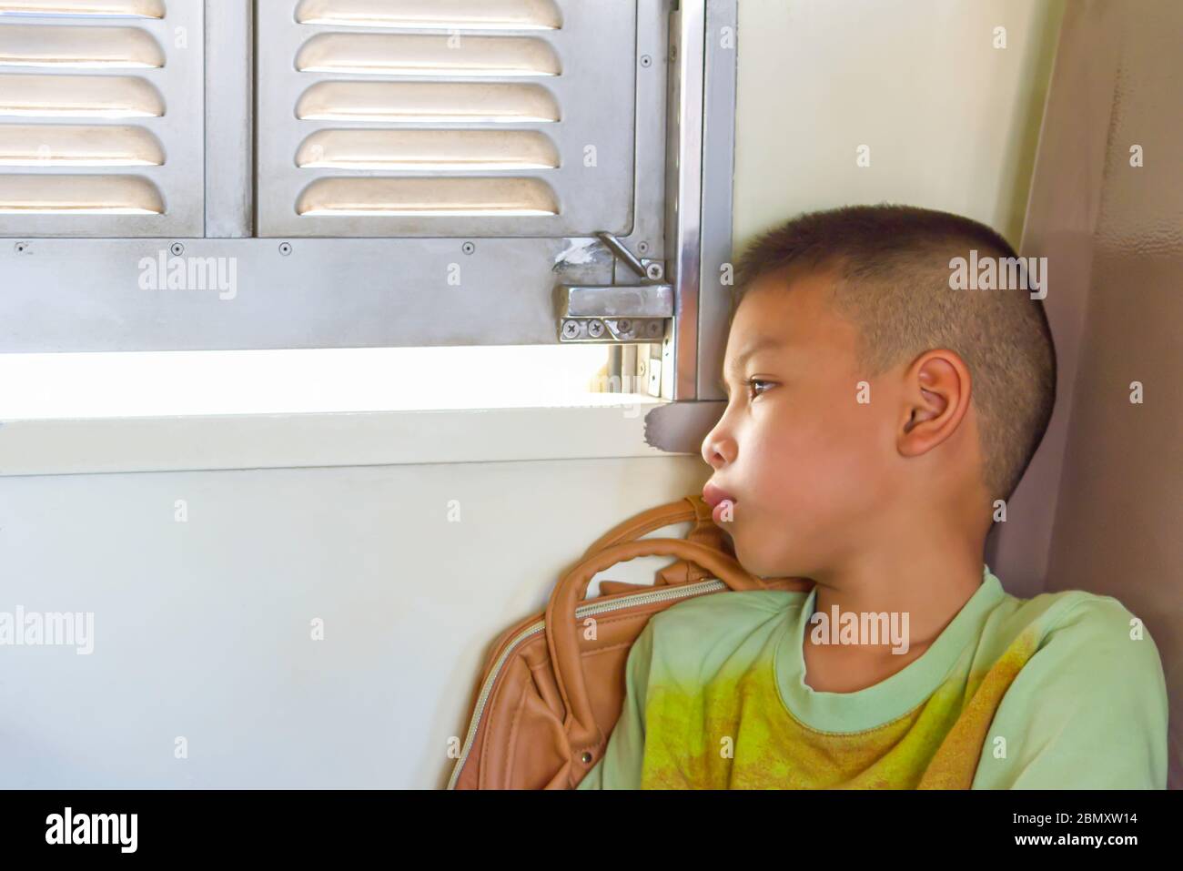 Portrait of asian boy on the train background window views. Stock Photo