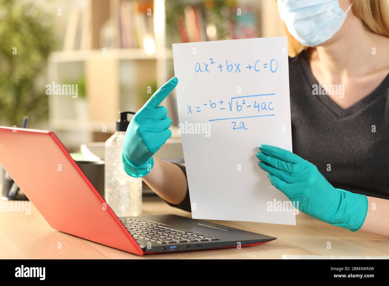 Close up of teacher woman hands teaching online course on laptop videocall during coronavirus confinement at home Stock Photo