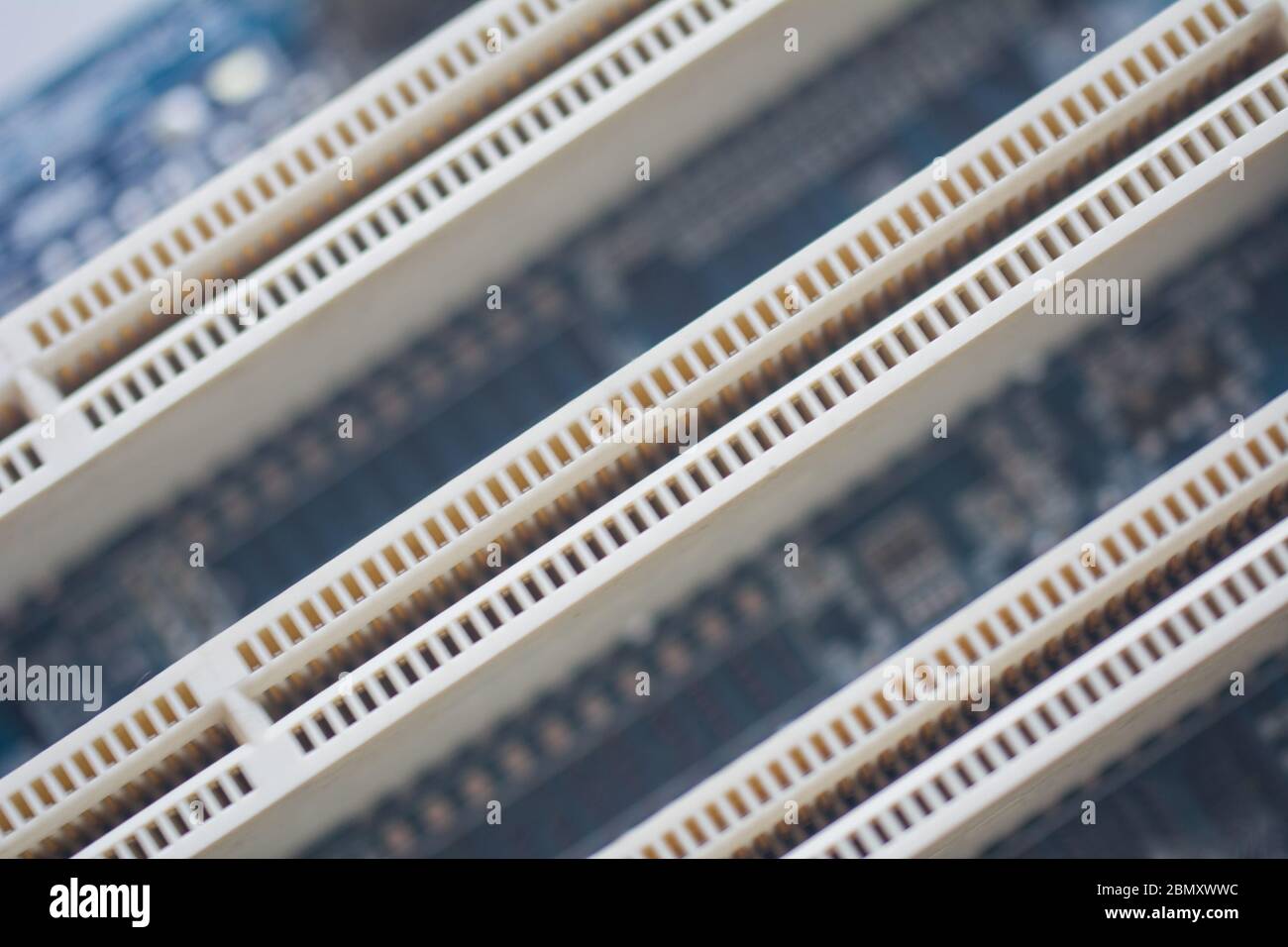 Closeup on empty pci or ram slots on a modern blue motherboard. Electronics, technology, pc components concept Stock Photo