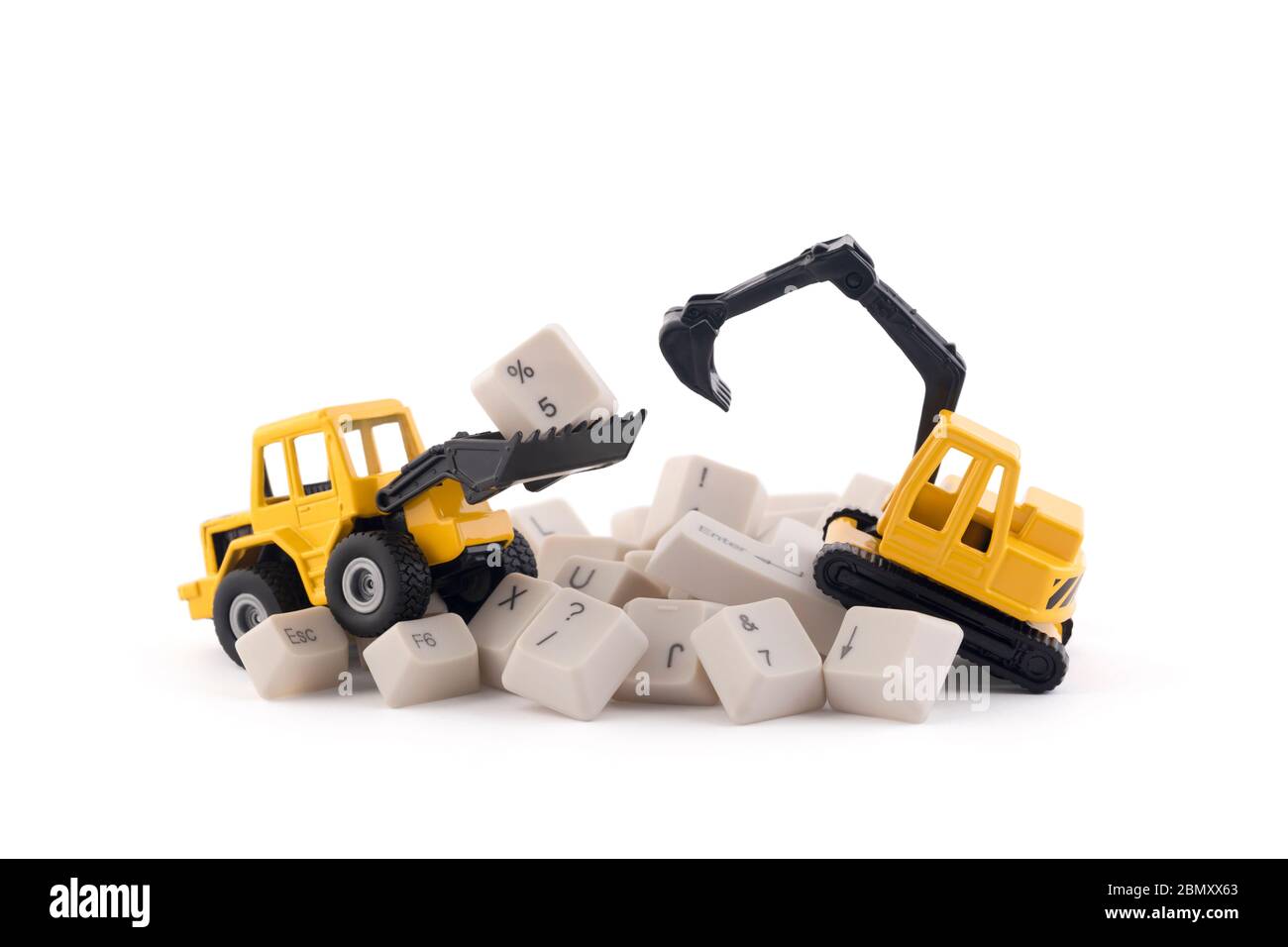 Bulldozer and excavator working on computer keys isolated on white background with clipping path. Website under construction concept. Stock Photo
