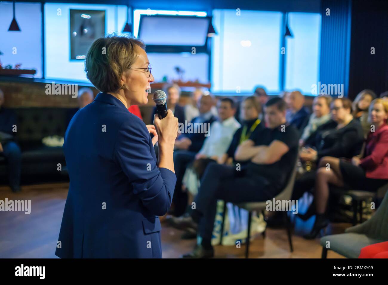 Female presenter speaks to audiences Stock Photo - Alamy