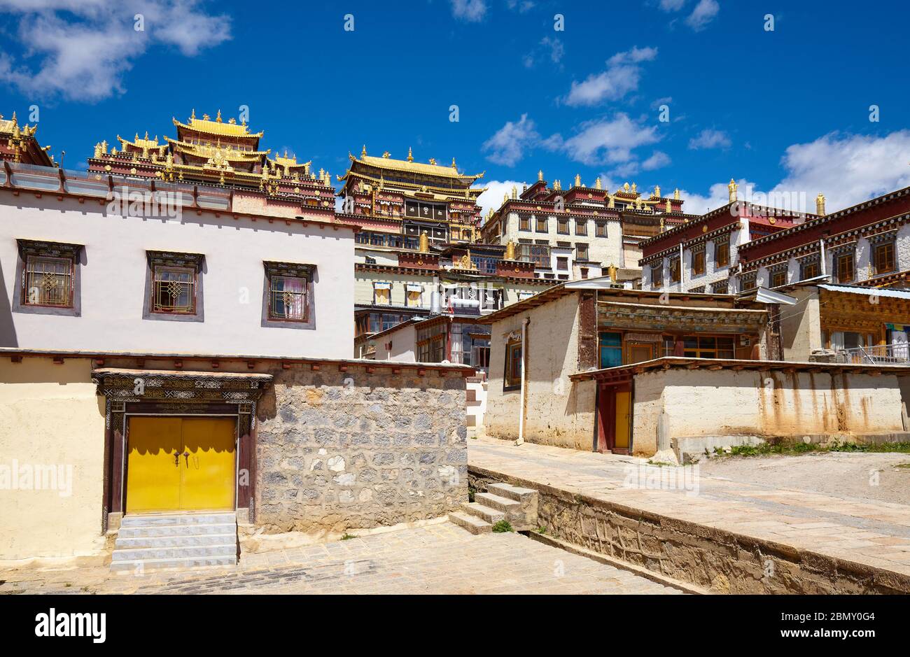 Songzanlin Monastery on a sunny day (also known as Sungtseling, Ganden Sumtsenling or Little Potala Palace), Yunnan, China. Stock Photo
