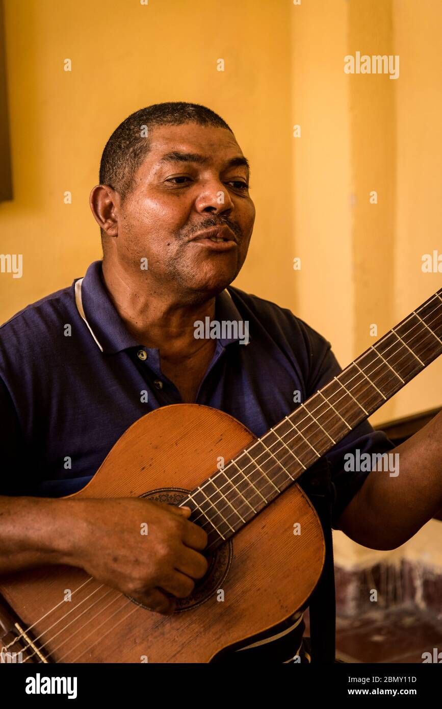 Music teacher singing and playing the guitar at the Arts centre Casa