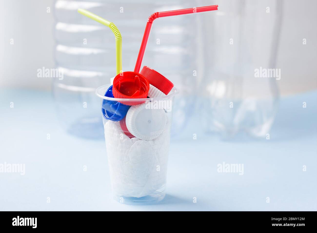 Danger cocktail from plastic bag and bottle caps with colorful straw ...