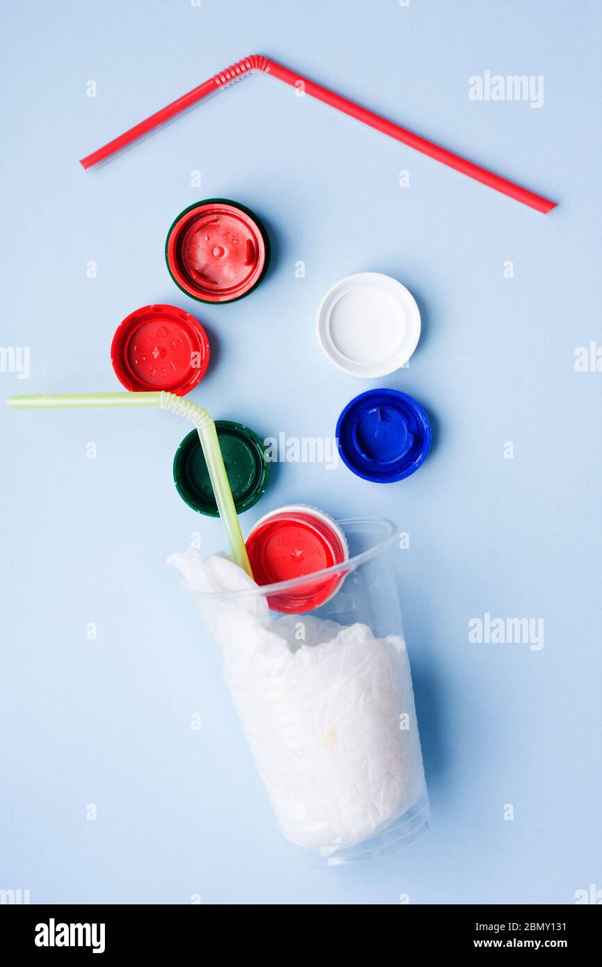 Danger cocktail from plastic bag and bottle caps with colorful straw ...