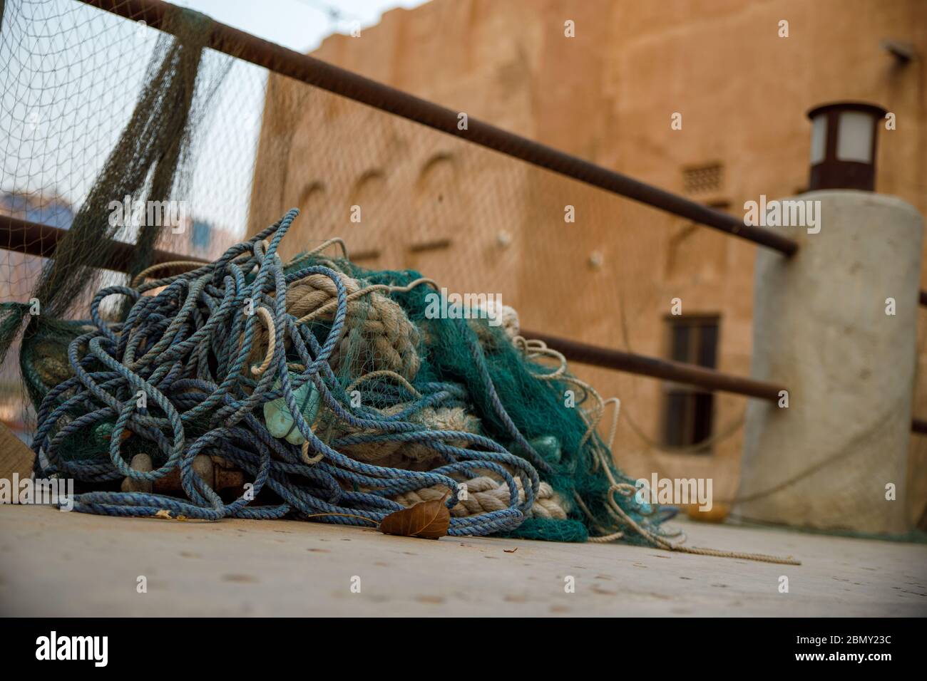 Fishing nets, buoys and floats on pavement not being used in old town Dubai Stock Photo