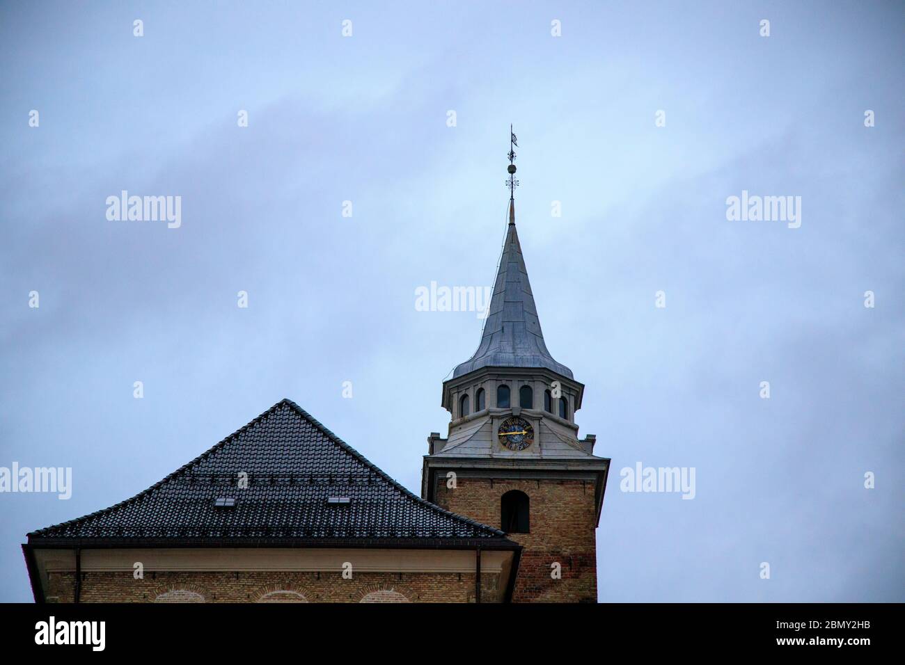 Akershus Fortress is a historical medieval castle structure in Oslo, Norway which has gardens, cannons, and beautiful views from the surrounding parap Stock Photo