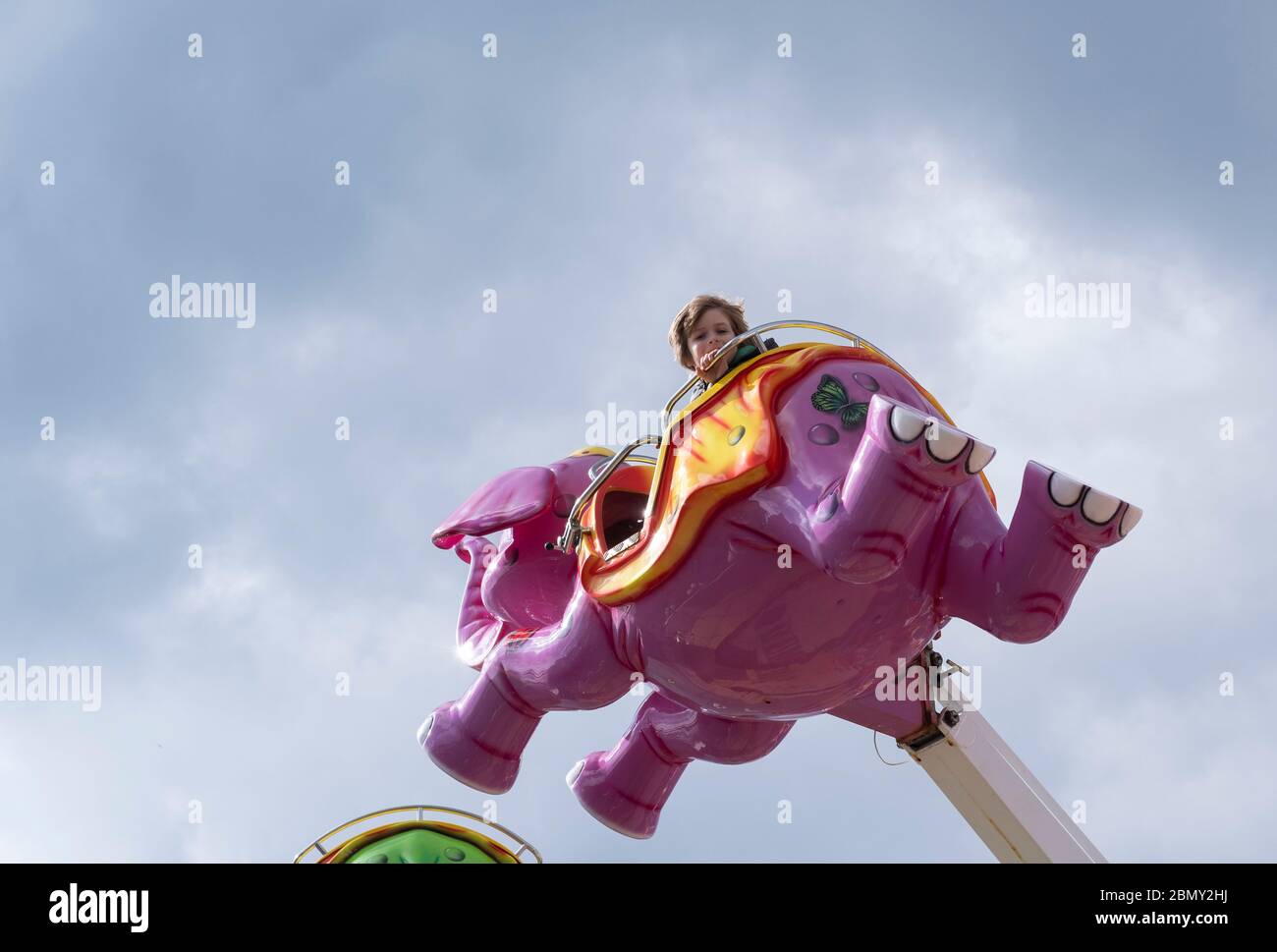 A young boy enjoying a fairground ride on the Largs seafront. Stock Photo