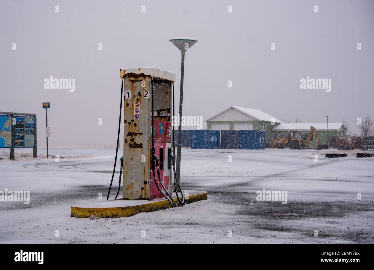 Fuelling gas and petrol station on an icy road in Iceland during a snow storm in spring Stock Photo