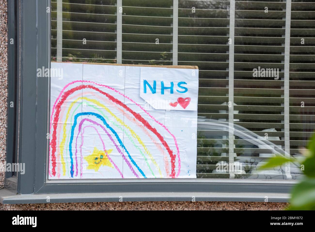 Sheffield UK –  April 09 2020: A Rainbow drawing in a window shows support for the NHS during the Covid-19 lockdown at Richmond Park Road Stock Photo
