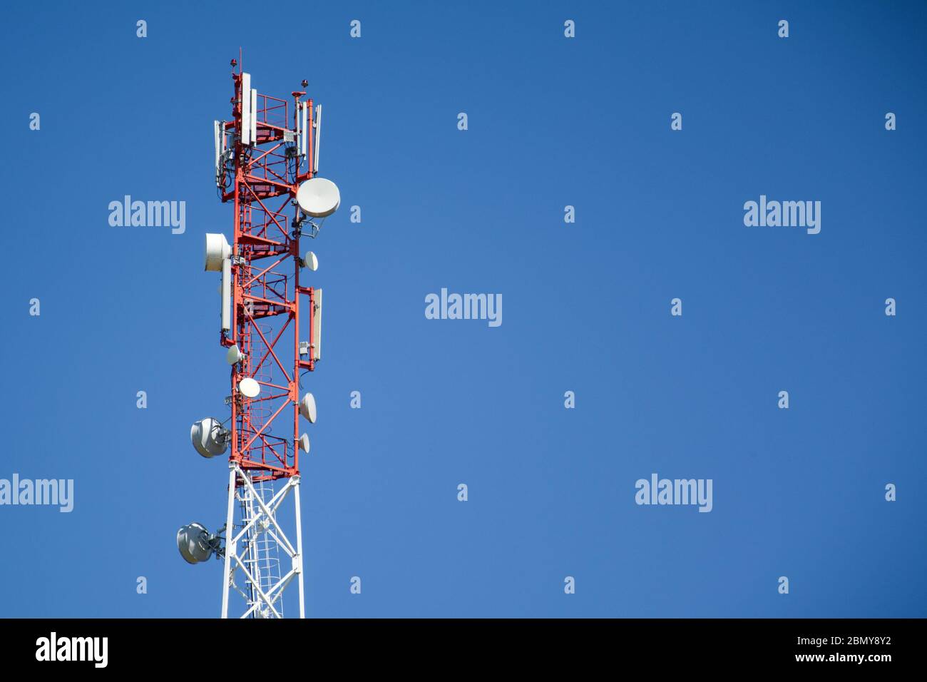 Base Station Telecommunication tower. Wireless Communication Antenna Transmitter on blue background with copyspace. 4g or 5G Network Connection Concep Stock Photo