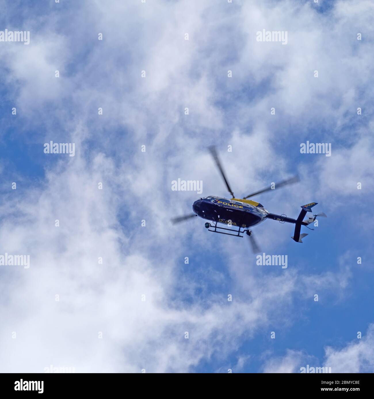 BIDEFORD, DEVON, ENGLAND, UK - MAY 11 2020: A blue and yellow police helicopter patrols the skies of north Devon. Stock Photo