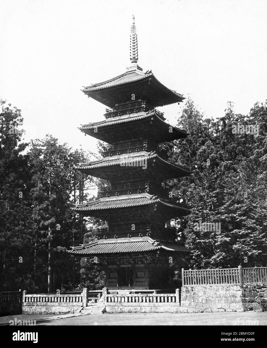 [ 1890s Japan - Japanese Pagoda, Nikko ] —   Five-storied pagoda in Nikko, Tochigi Prefecture.  From a series of glass slides published (but not photographed) by Scottish photographer George Washington Wilson (1823–1893). Wilson’s firm was one of the largest publishers of photographic prints in the world.  19th century vintage glass slide. Stock Photo