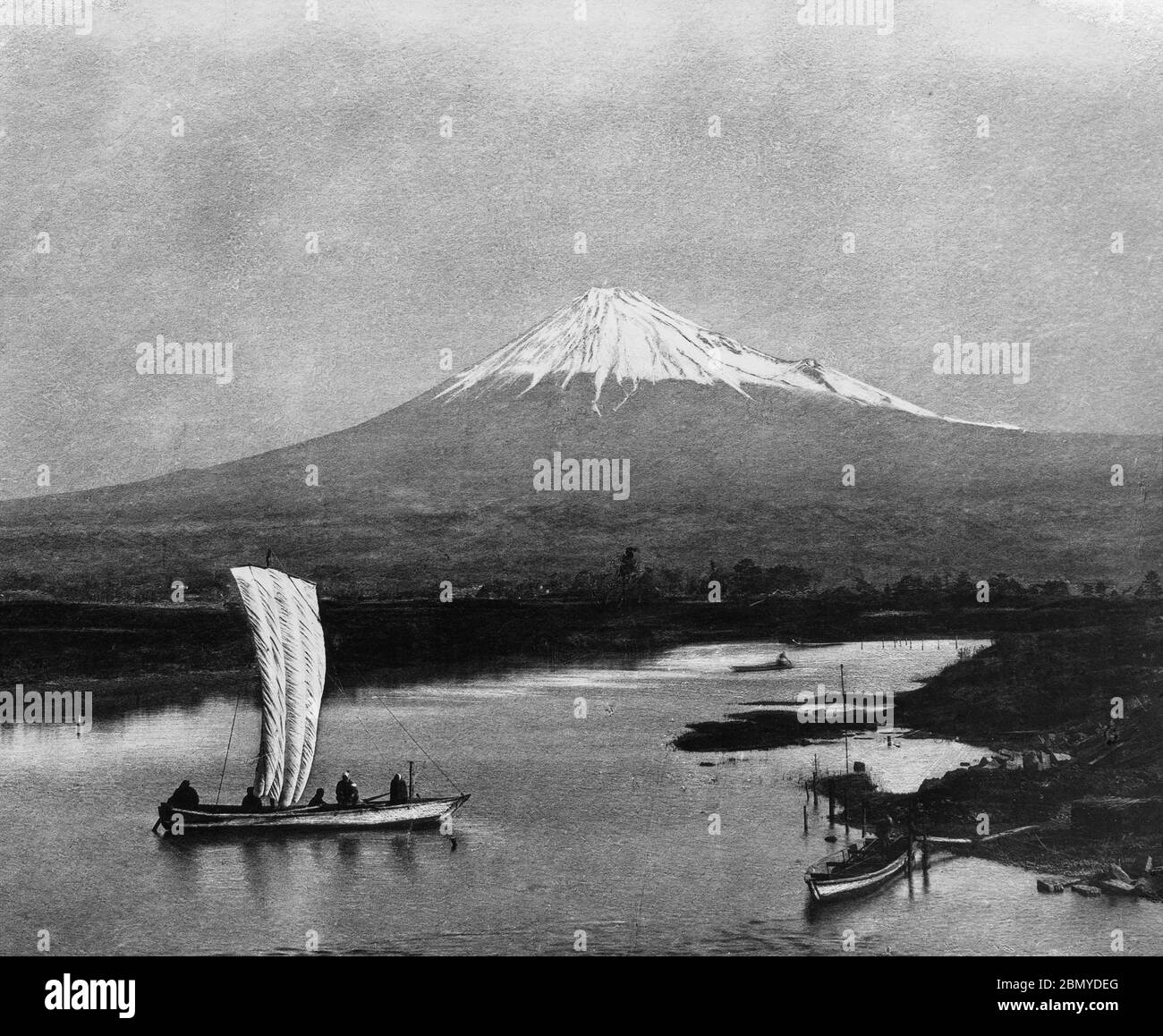 [ 1890s Japan - Mount Fuji ] —   Mount Fuji as seen from the Numakawa River (沼川) in Shizuoka Prefecture. A small sailing vessel can be seen.   From a series of glass slides published (but not photographed) by Scottish photographer George Washington Wilson (1823–1893). Wilson’s firm was one of the largest publishers of photographic prints in the world.  19th century vintage glass slide. Stock Photo