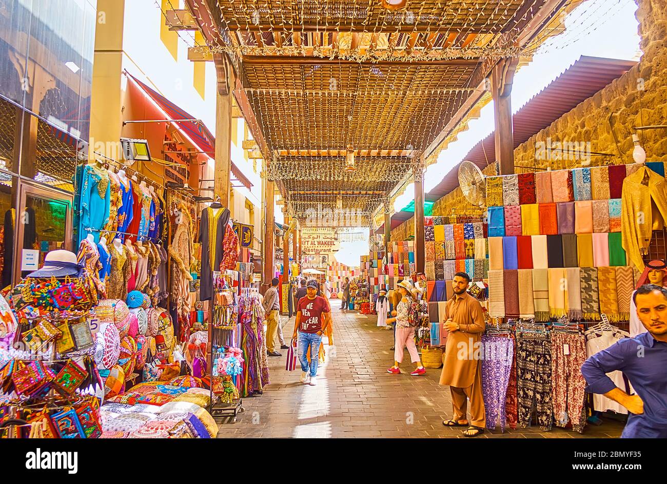 DUBAI, UAE - MARCH 2, 2020: The narrow alleyway of Bur Dubai Grand Souq  (bazaar, market), lined with stalls, offering garment, souvenirs, cashmere  sca Stock Photo - Alamy
