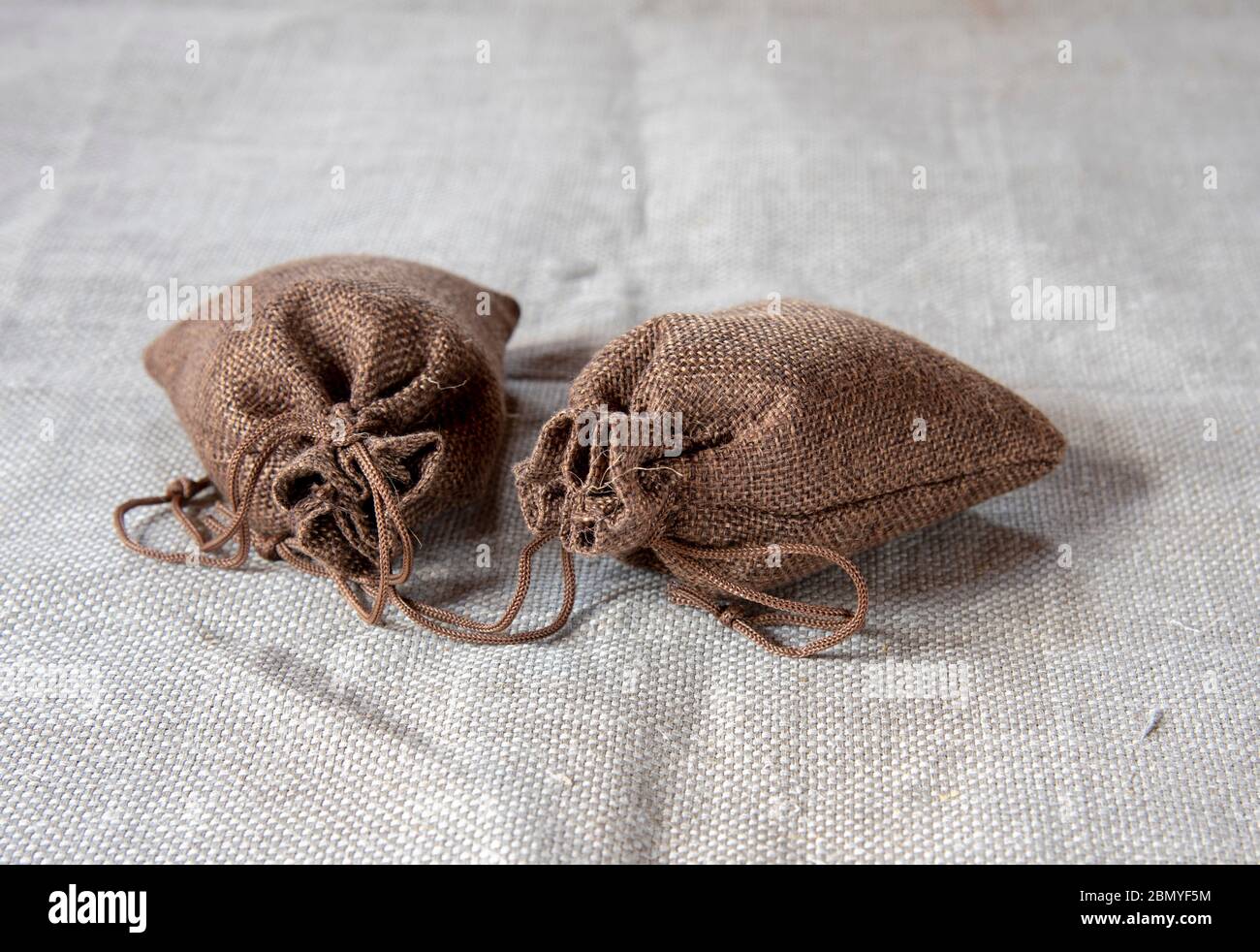 Two canvas bags with ties on a linen cloth Stock Photo Alamy