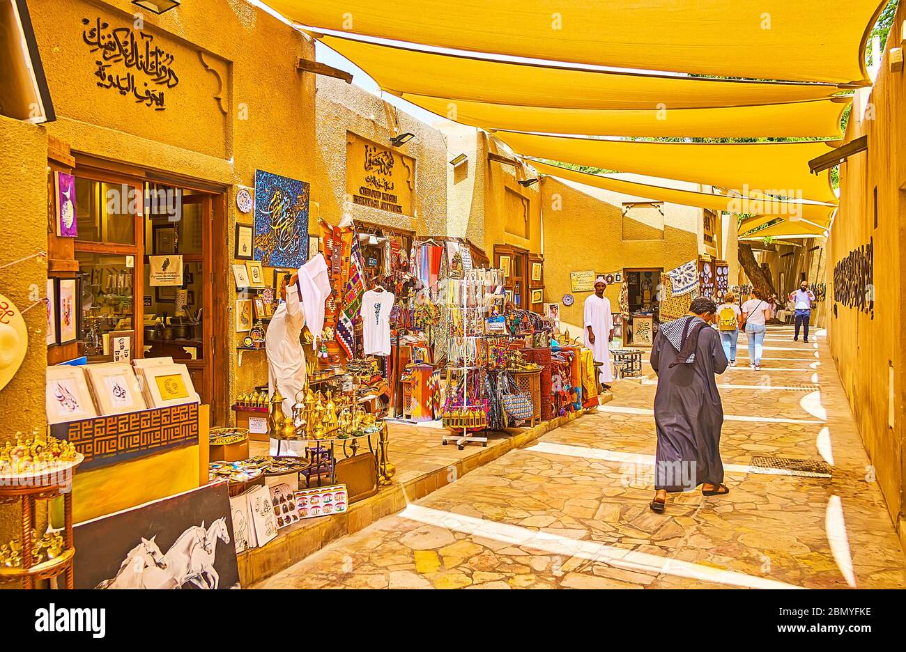 DUBAI, UAE - MARCH 2, 2020: The shady streeet of Al Fahidi district art galleries and stores of Al Souq Al Kabeer market, offering traditional crocker Stock Photo