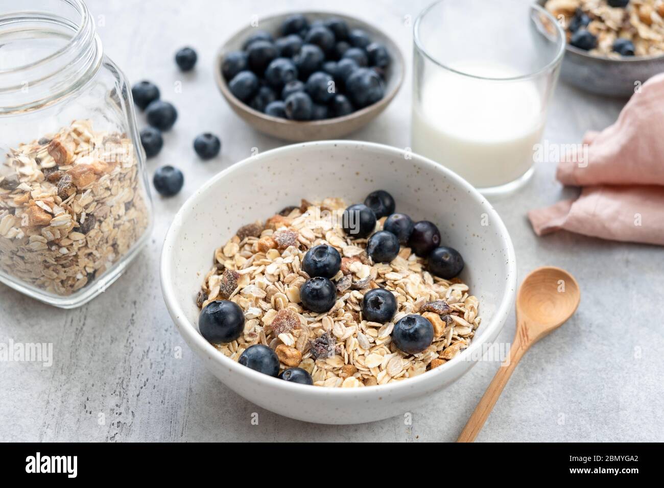 Breakfast cereals in bowl served with almond milk and blueberries