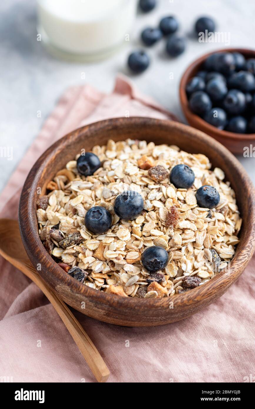 Breakfast cereals oat muesli in wooden bowl. Healthy eating, dieting