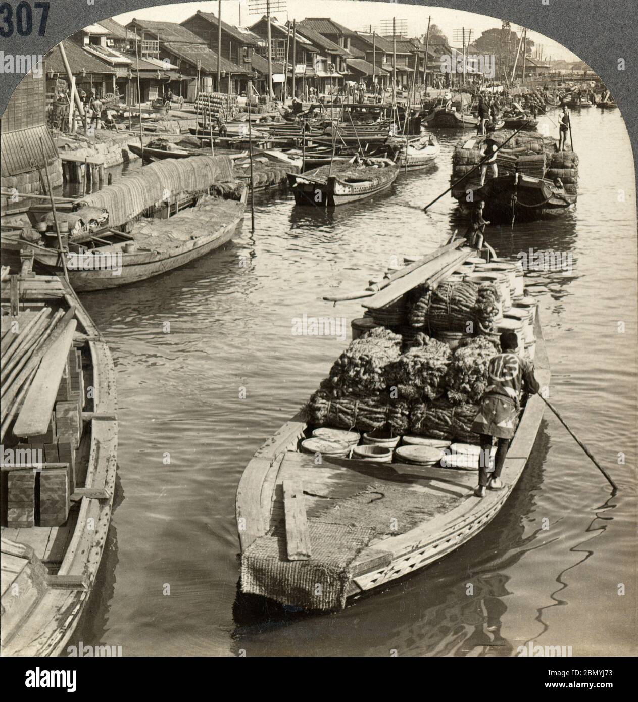 [ 1900s Japan - Japanese Cargo Boats, Tokyo ] —   Cargo boats west from the Nihonbashi bridge in Tokyo.  20th century vintage stereoview. Stock Photo