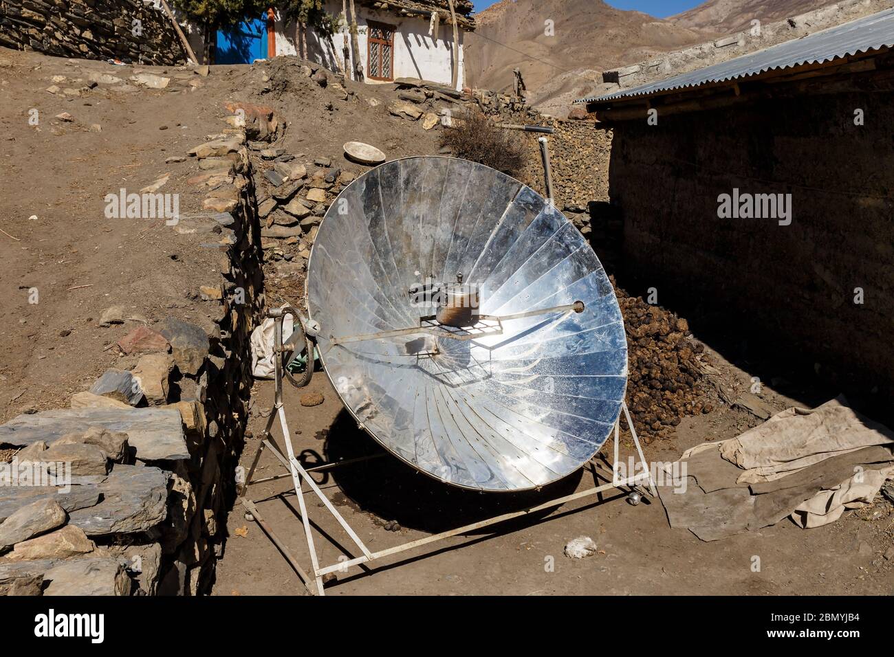 Solar parabolic heater for cooking in the mountain villages of Nepal. Himalayas. Stock Photo