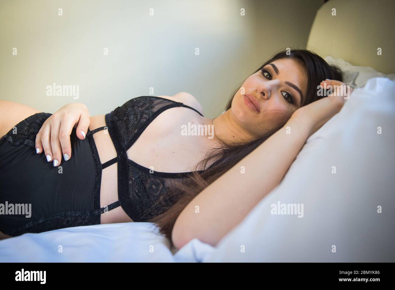 A young caucasian woman wearing lingerie at a boudoir location. Stock Photo