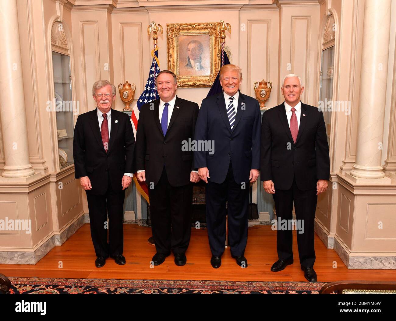 Secretary Pompeo Poses for a Photo With U.S. Secretary of State Mike Pompeo poses for a photo with (L to R) National Security Advisor of the United States John Bolton, President Donald J. Trump and Vice President Mike Pence before his swearing-in ceremony at the U.S. Department of State in Washington, D.C., on May 2, 2018. Stock Photo