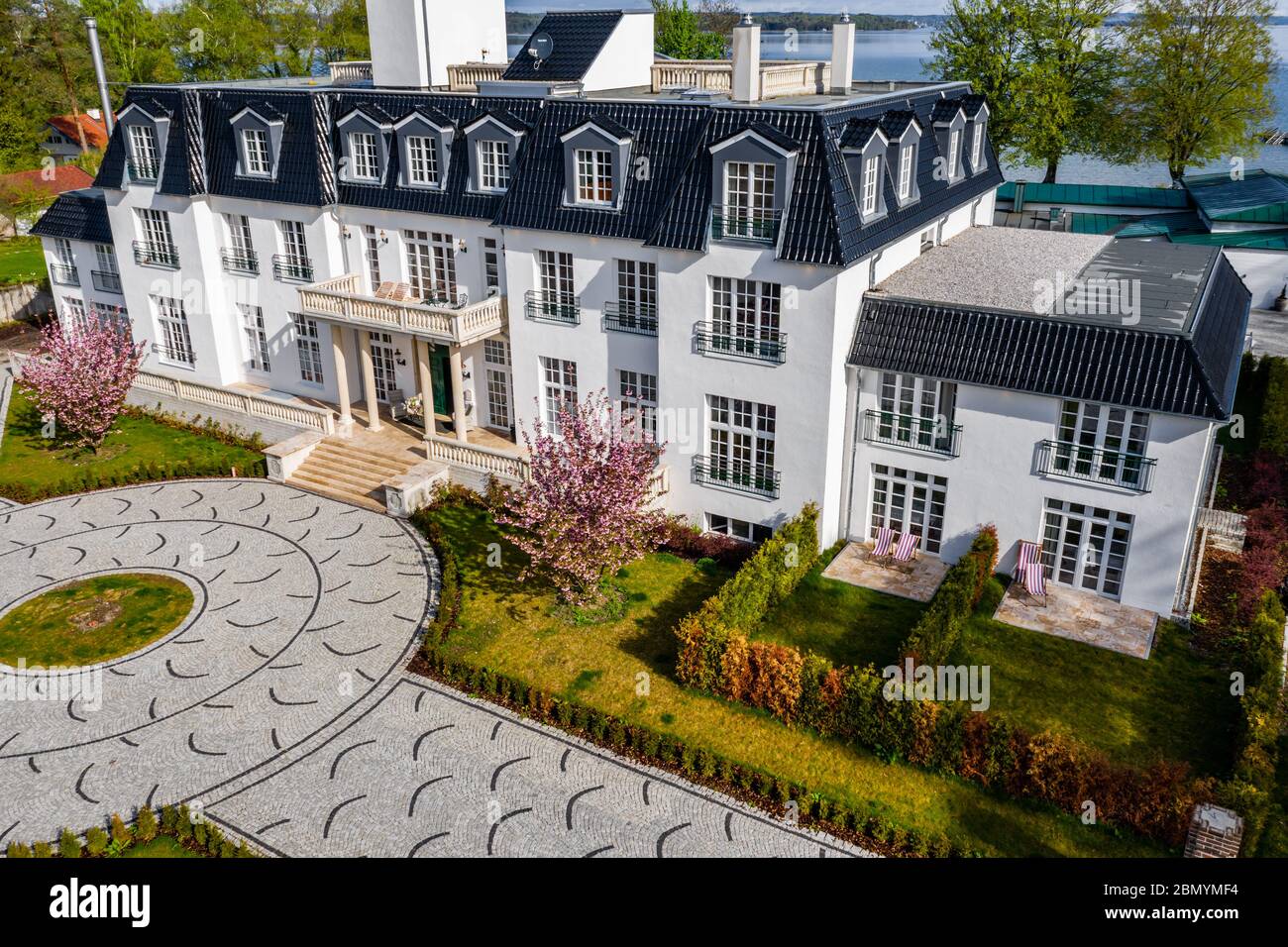 Germany, Munich, 26 April 2019: Aerial view of yard of the white building  in a sunny weather, luxury life, a lake on background, green lawn and Stock  Photo - Alamy