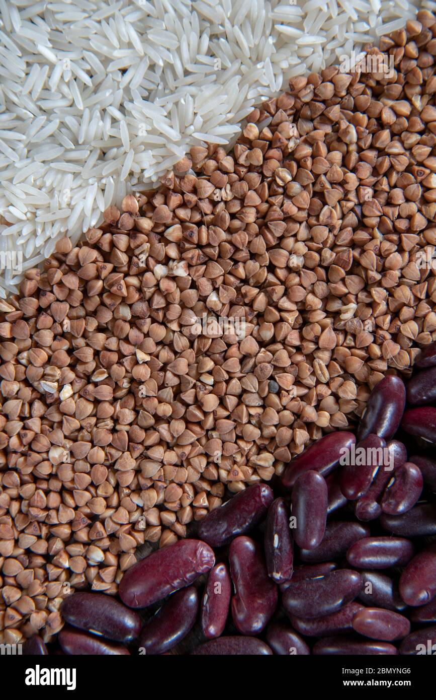 Raw Rice Beans Raw rice, buckwheat and beans are laid out in strips as a backdrop ...