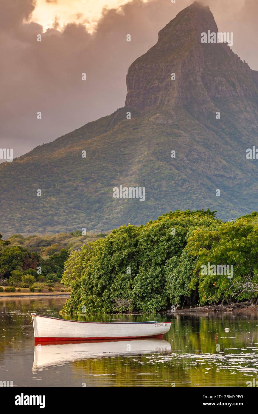 Boat in Tamarin Bay sheltered by Rempart Mountain, Black River district
