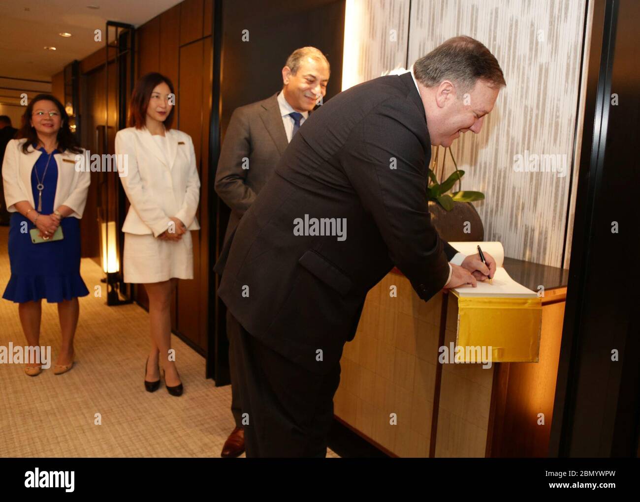 Secretary Pompeo Signs Guest Book in Singapore U.S. Secretary of State Mike Pompeo meets staff and signs the guest book at the Shangri-La Hotel in Singapore, June 13, 2018. Stock Photo