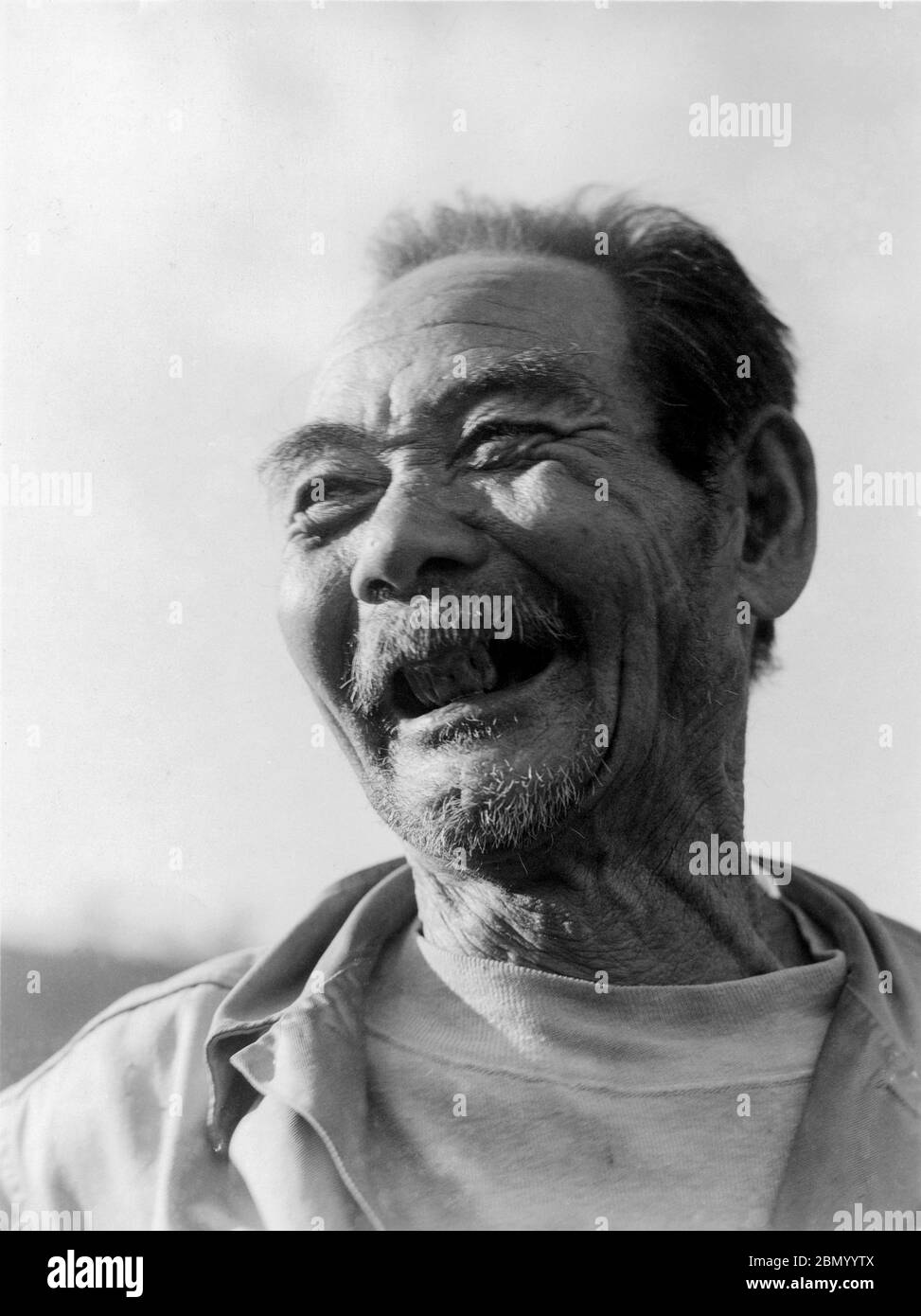[ 1946 Japan - Smiling Okinawan ] —   Close up of a smiling elderly man in Okinawa, 1946 (Showa 21).  20th century gelatin silver print. Stock Photo