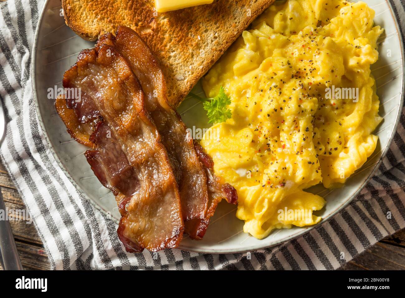 Homemade American Scrambled Egg Breakfast with Bacon and Toast Stock Photo
