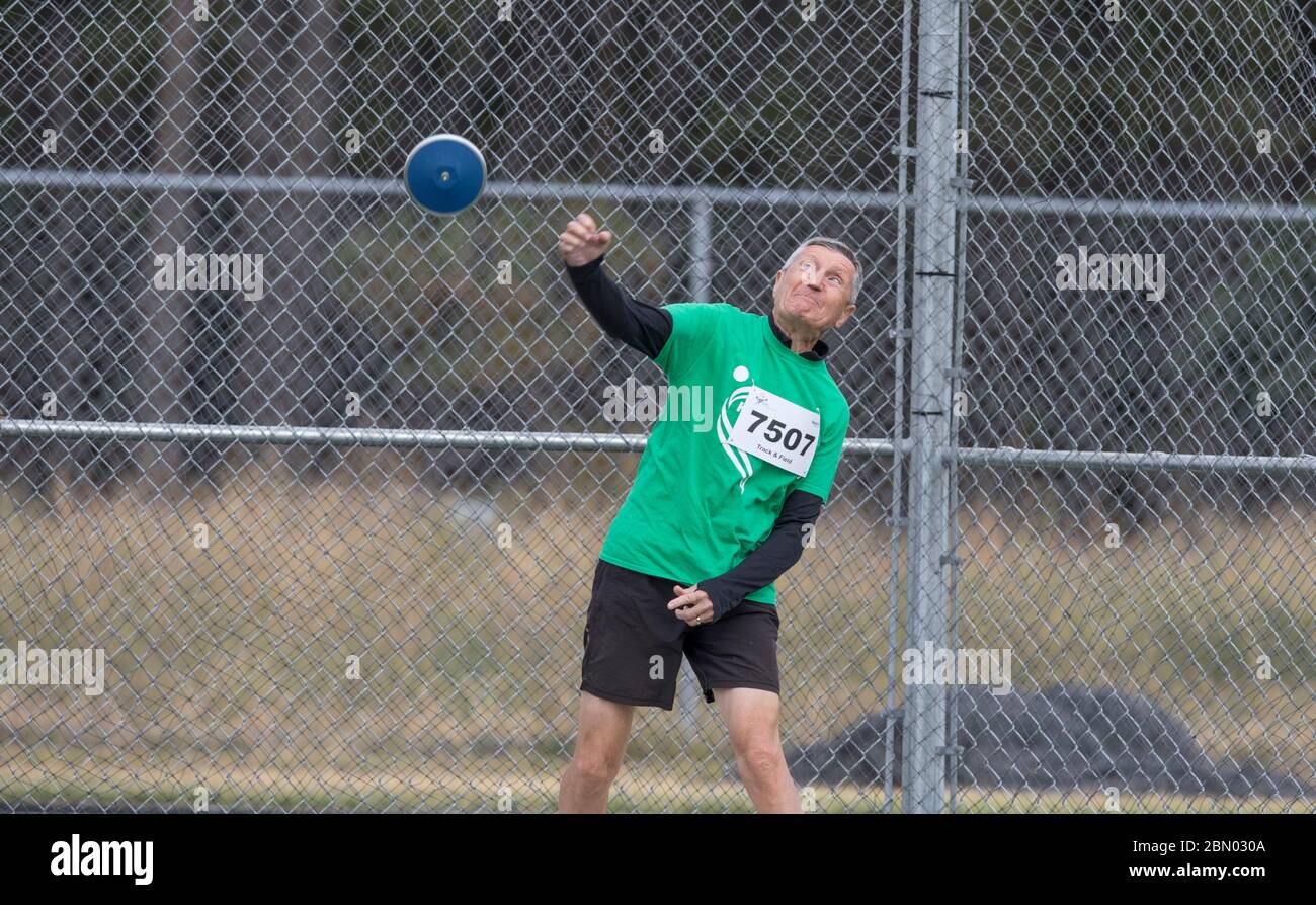 Men's discus throw, age group 75 years old. Right after release Stock