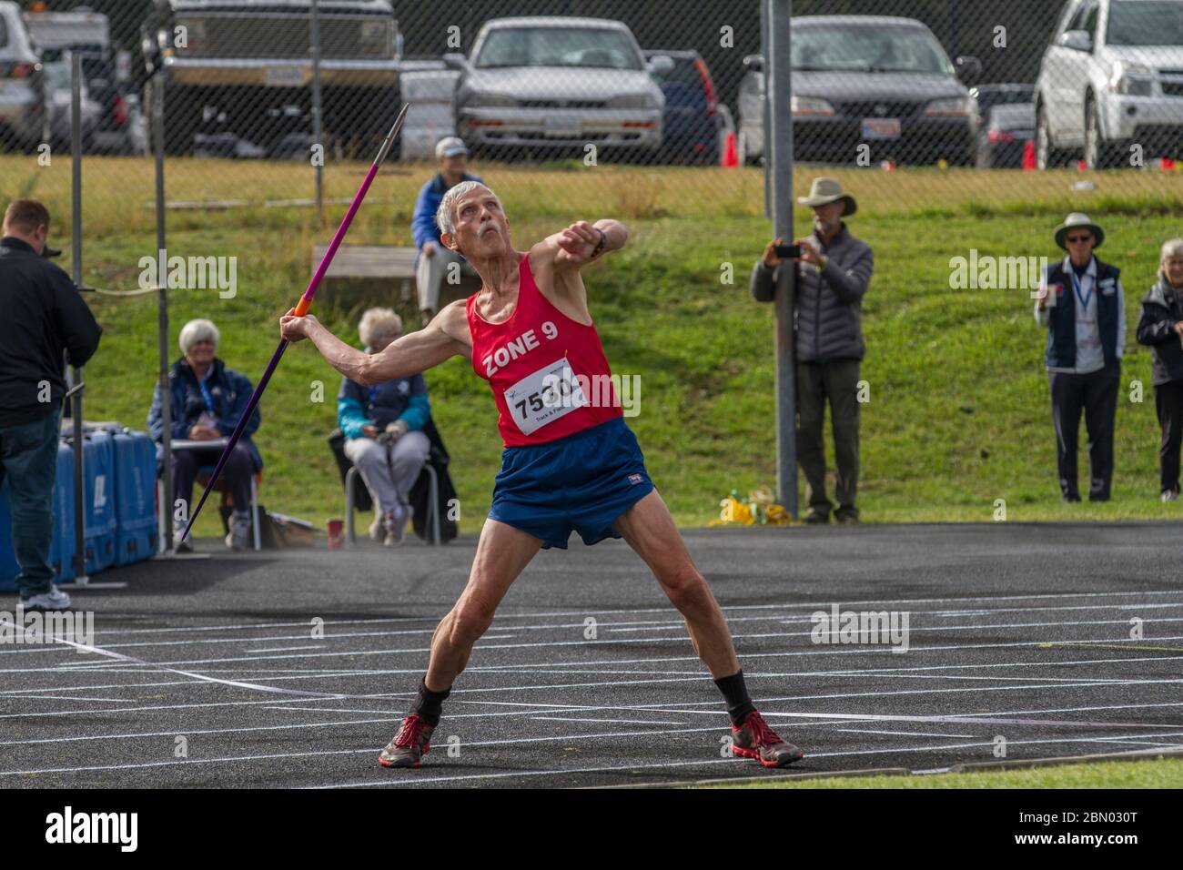Competing in javelin throw, 75 year old male. Just before release. Stock Photo