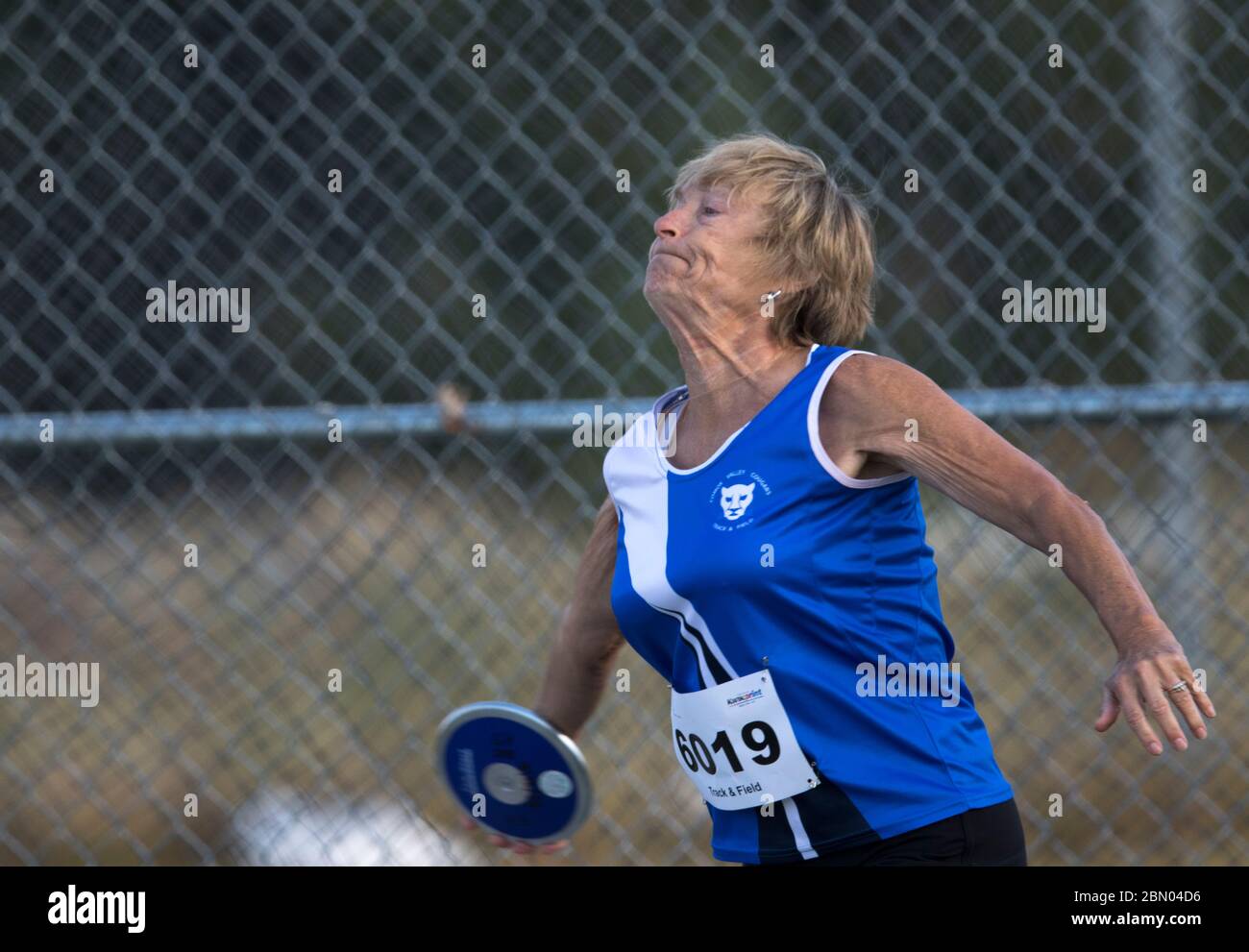 Senior Ladies Discus Throw competition. 60 year old age group, getting set to release. Stock Photo