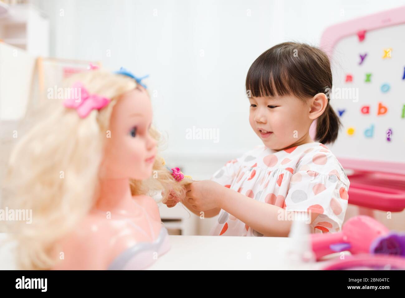 toddler girl pretend play as hairdresser at home Stock Photo - Alamy
