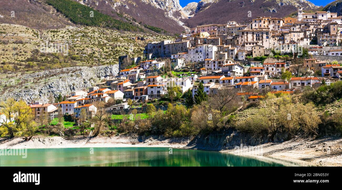 traditional Italy. Beautiful emerald lake in Abruzzo mountains and scenic village. Lago di Barrea Stock Photo