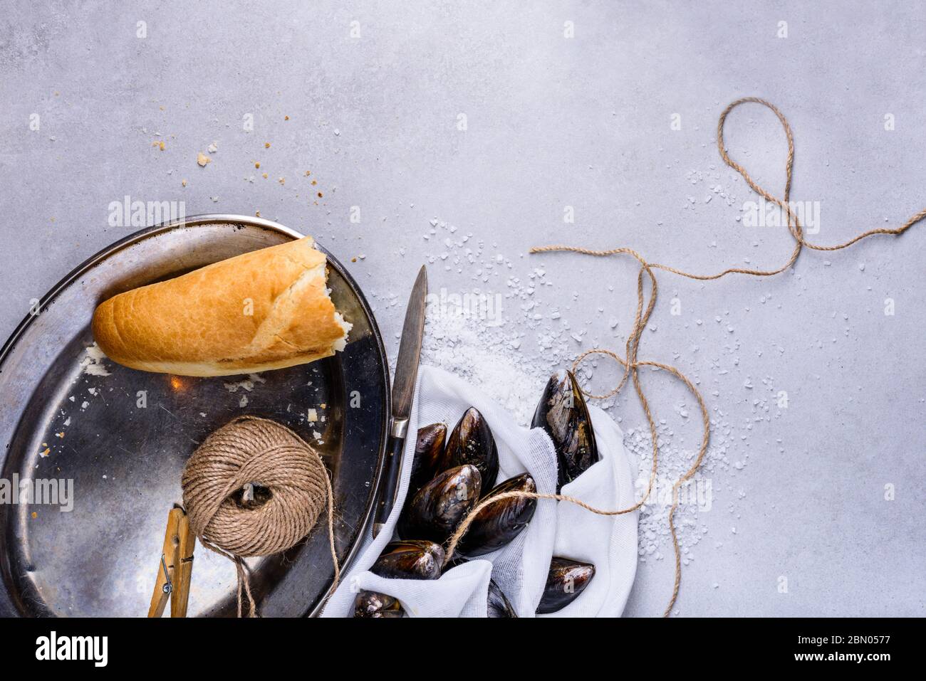 Mussels or clams, shellfish on light background, text space. Overhead view. Stock Photo