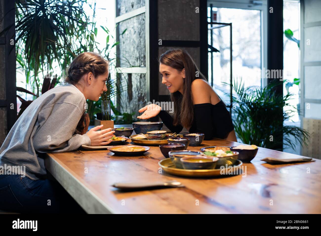 Good looking girls having a lunch in a fancy cafe, girls chattin Stock Photo