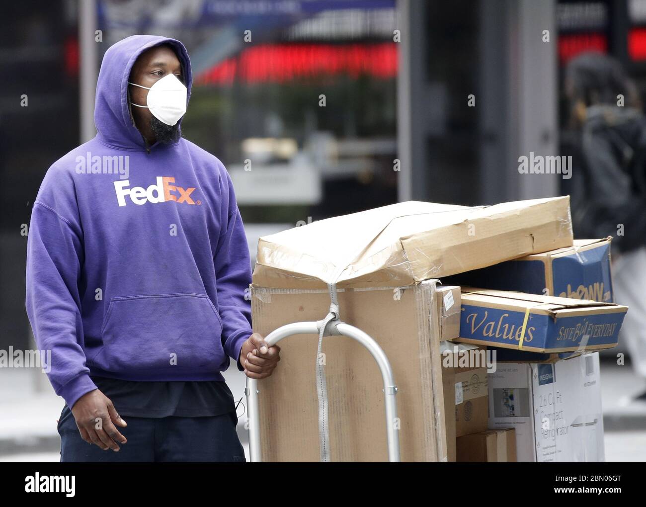 New York, United States. 11th May, 2020. A Federal Express FedEx worker pulls a cart of packages in Times Square in New York City on Monday, May 11, 2020. The Coronavirus pandemic has killed over 20,000 people in New York City and has accounted for over 280, 00 deaths worldwide. Photo by John Angelillo/UPI Credit: UPI/Alamy Live News Stock Photo