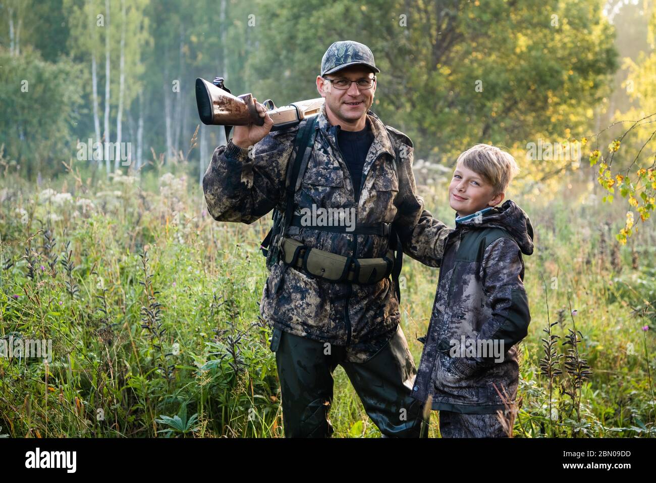Father teaching his son about gun safety and proper use on hunting in