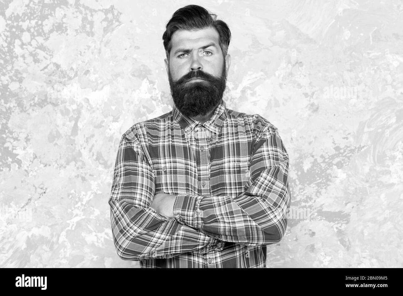 mature guy casual style. confident male hipster after barbershop. professional hairdresser in checkered shirt. brutal bearded man grunge background. serious man with lush beard and moustache. Stock Photo