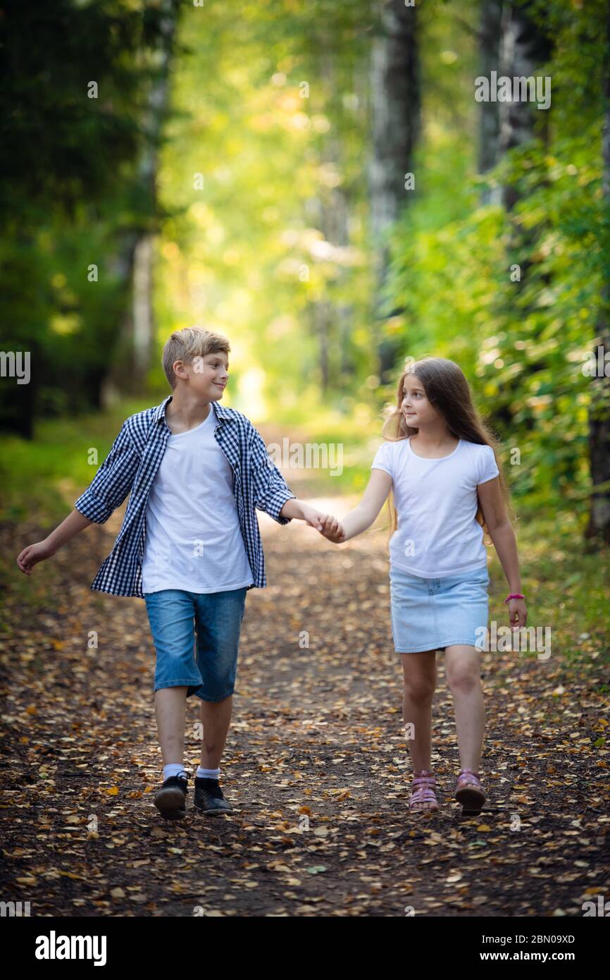 First Love Little Boy And Girl Holding Hands And Smiling While Walking Outdoors In Park Stock Photo Alamy First Love Little Boy And Girl Holding Hands And Smiling While Walking Outdoors In Park Stock Photo Alamy