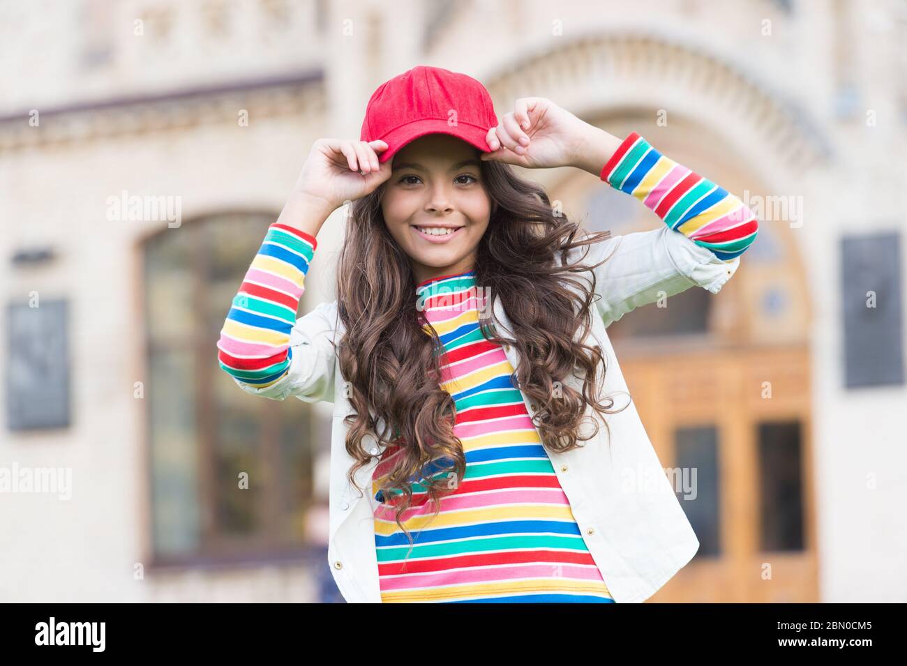 Dress like real hipster. Happy child enjoy hipster style. Little hipster  wear baseball cap outdoors. Hipster look of small girl. Fashion accessory.  Trendy style. Streetwear. Funky beauty Stock Photo - Alamy