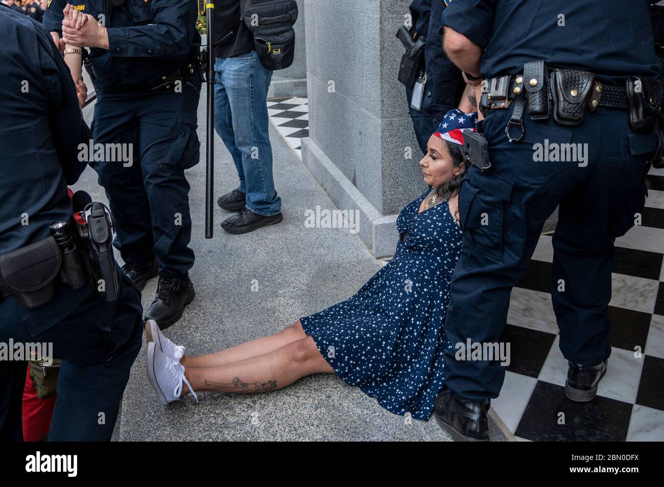 Sacramento, California, USA. 2nd May, 2019. A protester is arrested at the Capitol in Sacramento on May Day, while demonstrating against California Gov. Gavin Newsom's stay-at-home order to slow the spread of the coronavirus. Credit: Renee C. Byer/Sacramento Bee/ZUMA Wire/Alamy Live News Stock Photo