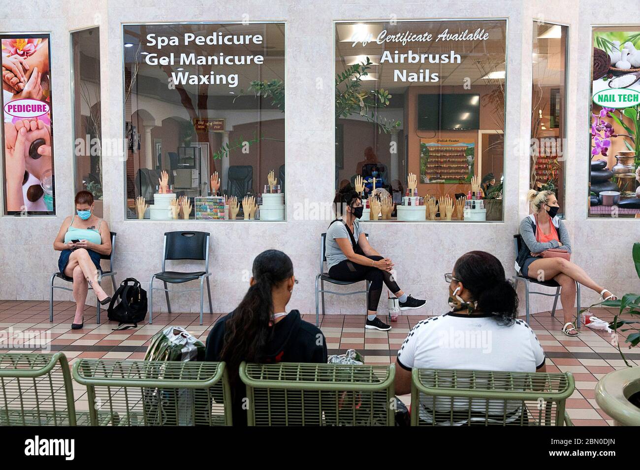 Yuba City, California, USA. 6th May, 2020. Customers sit apart wearing face masks waiting for their manicure at Nail Tech in the Yuba-Sutter Mall in Yuba City during the coronavirus pandemic. Credit: Paul Kitagaki Jr/Sacramento Bee/ZUMA Wire/Alamy Live News Stock Photo