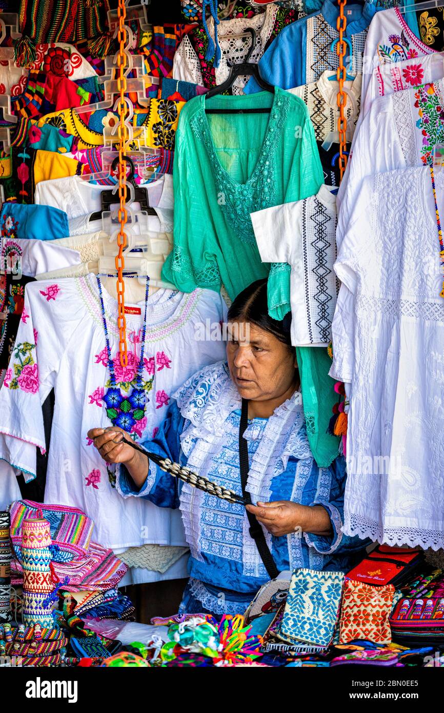 A vendor surrounded by her wares in the artisan market of Valle de Bravo in the state of Mexico, Mexico. Stock Photo