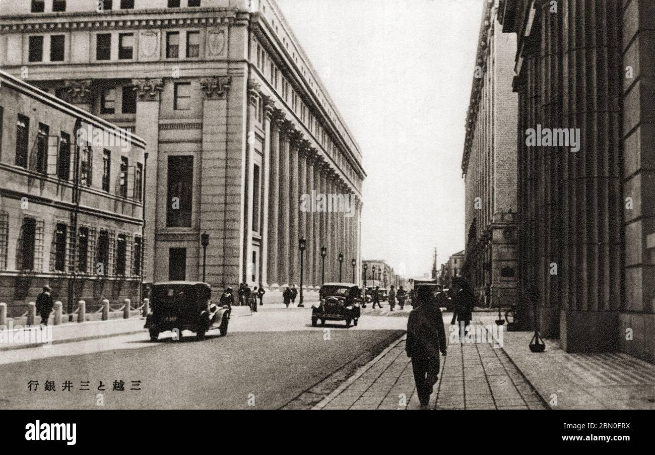 [ 1930s Japan - Mitsui Bank, Tokyo ] —   Mitsui Bank (三井銀行) in Tokyo's Nihonbashi district, ca. 1930s.  The company was originally founded as Echigoya by Mitsui Takatoshi (1622–1694) in Mie prefecture.  On July 1, 1876 (Meiji 9), the company founded Japan’s first private bank, Mitsui Bank. The bank survives as the Sumitomo Mitsui Banking Corporation.  This image has kind of a soft focus and is grainy.  20th century vintage postcard. Stock Photo