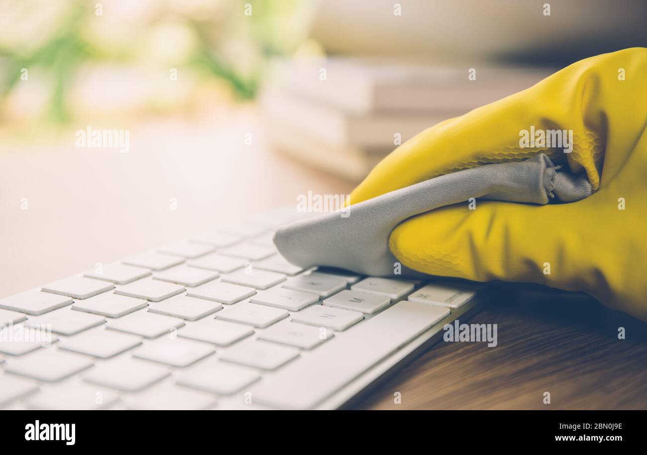 Hand of man cleaning keyboard computer with antibacterial for protect ...